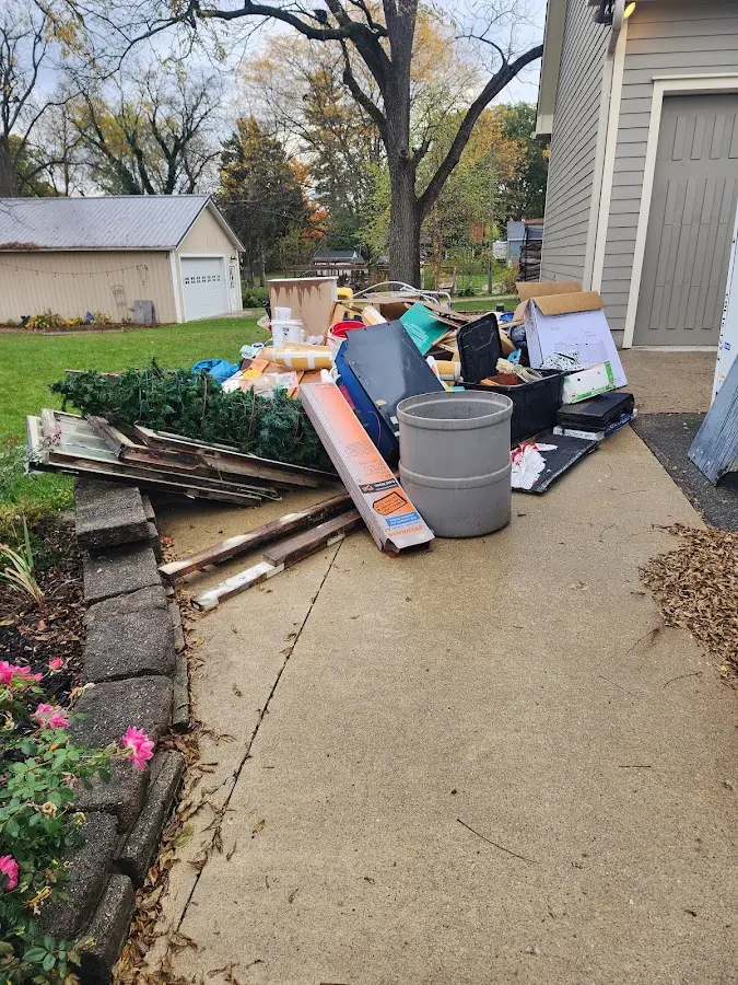 Dumpster being loaded with debris for Estate Cleanout Dumpster Rental in Altamonte Springs